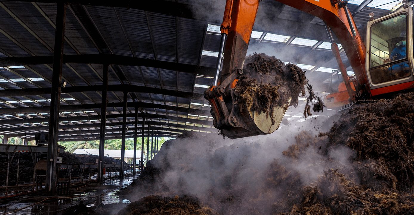 Excavator handling steaming mill biomass at an AMR site